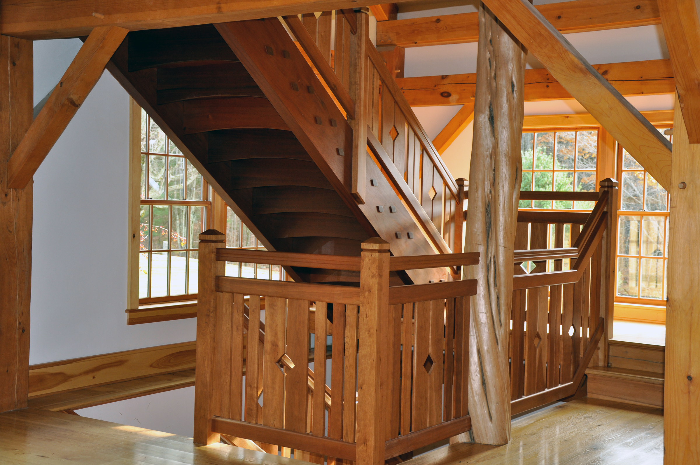 cherry timber frame staircase with organic tree shape.